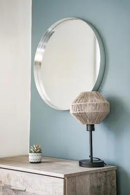 a table with a mirror and a lamp on it at Elm House in Bathgate
