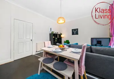 a living room with a table and a couch at Elmbank Apartment by Klass Living Bellshill in Bellshill