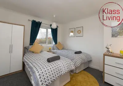 a bedroom with two beds and a dresser at Kenmar House by Klass Living Hamilton in Hamilton