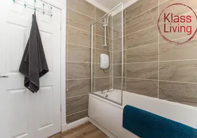 a bathroom with a shower and a tub and a toilet at Kenmar House by Klass Living Hamilton in Hamilton