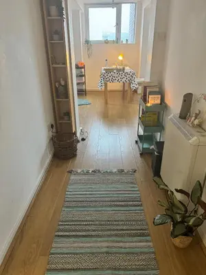 a living room with a table and a refrigerator at Skyline Serenity Cosy Home in Glasgow