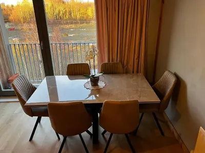 a dining room table with chairs and a large window at Luxury New York Style Loft Apartment Homestay in Edinburgh