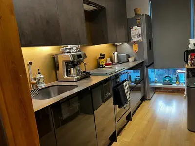 a kitchen with a sink and a microwave at Luxury New York Style Loft Apartment Homestay in Edinburgh