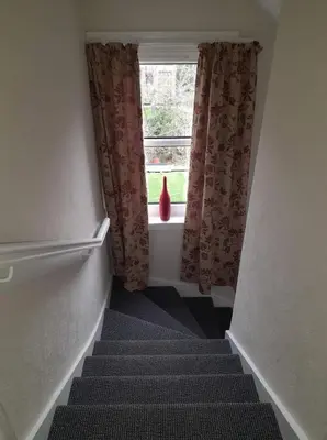 a stairway with a window and a stair case at Celia's house in Stirling
