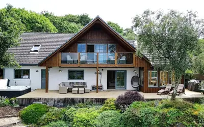 a home with a large deck with a house at Scone Cottage - Luxury retreat, outstanding views in Craobh Haven