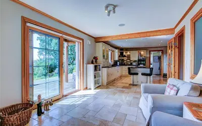 a living room with a couch and a kitchen at Scone Cottage - Luxury retreat, outstanding views in Craobh Haven