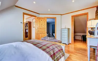 a bedroom with a bed and a dresser at Scone Cottage - Luxury retreat, outstanding views in Craobh Haven