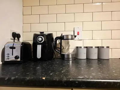 a counter top with a coffee maker and a toaster at Cozy 2Bed Flat in Glasgow City Center in Glasgow