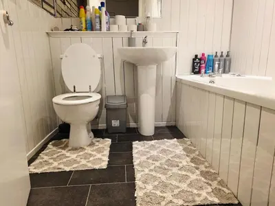 a bathroom with a toilet and a sink at Cozy 2Bed Flat in Glasgow City Center in Glasgow