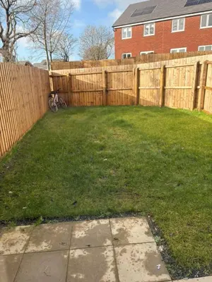 a yard with a fence and a bike in front of a house at 3,Lime Tree Ave in Moffat