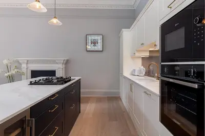a kitchen with black appliances and a white counter top at Victorian Apartment - city centre - free car space in Edinburgh