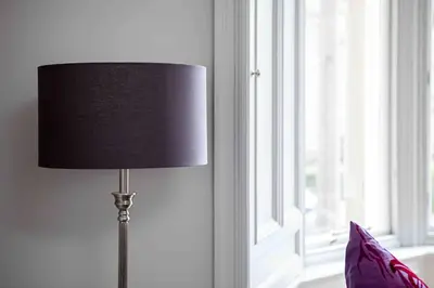 a lamp sitting in a room next to a window at Victorian Apartment - city centre - free car space in Edinburgh