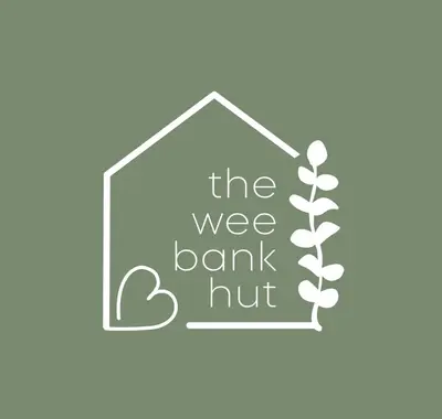 a blackboard with the words the wee bank nut and a plant at The Wee Bank Hut in Oban