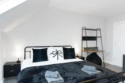 a bedroom with a bed with two towels on it at The Clydesider in Glasgow