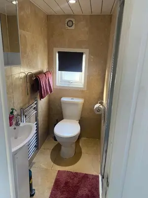 a small bathroom with a toilet and a sink at Bethany Woodland Lodge in Winchburgh