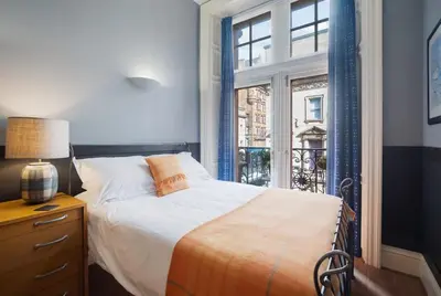 a bedroom with a bed and a window at West George Street Apartment Glasgow in Glasgow