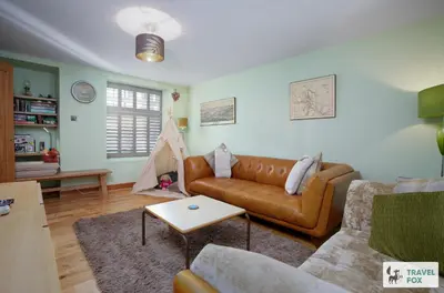 a living room with a couch and a table at Charlotte Street Stay in Port Ellen