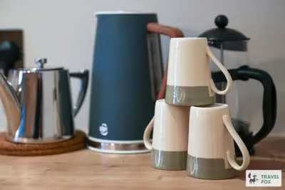 a group of coffee cups sitting on a counter at Charlotte Street Stay in Port Ellen