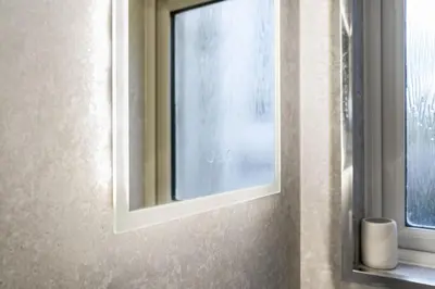 a mirror on a wall next to a window at O Hill Crescent 1 Bedroom Studio - Edinburgh in Edinburgh