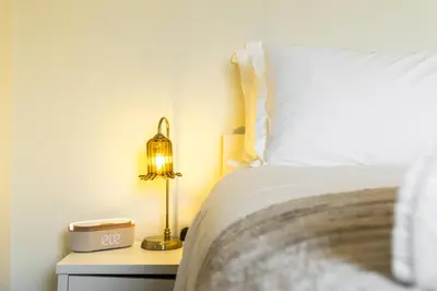 a bedroom with a bed and a lamp on a night stand at O Hill Crescent 1 Bedroom Studio - Edinburgh in Edinburgh