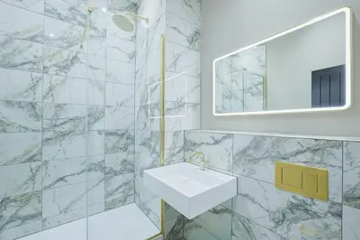 a white bathroom with a sink and a mirror at No 4 Burnbank in Oban