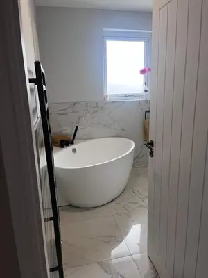 a white bath tub in a bathroom with a window at Scottish White House in Edinburgh