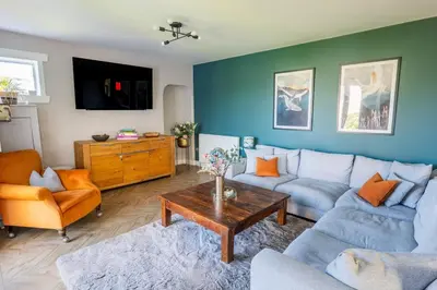 a living room with a couch and a table at Scottish White House in Edinburgh
