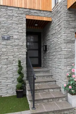 a stone building with a staircase leading to a door at The Loch Lomond Townhouse In The Centre of Balloch in Balloch