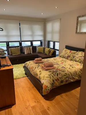 a living room with a bed and a couch at The Loch Lomond Townhouse In The Centre of Balloch in Balloch