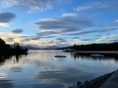 a view of a river with boats on the water at The Loch Lomond Townhouse In The Centre of Balloch in Balloch