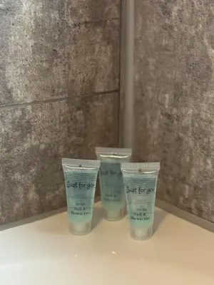 a group of four plastic cups sitting on a shelf at Modern 2BR Cottage Flat in Bellshill