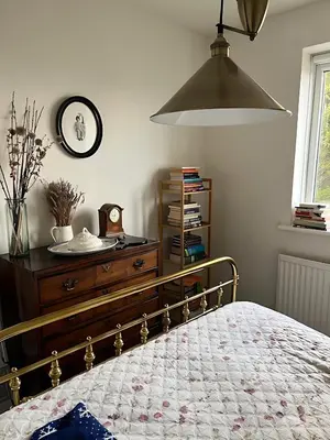 a bedroom with a bed with a dresser and a clock at Deal - The place to stay in Moffat
