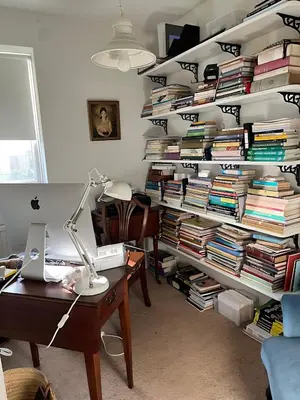 a room with a desk and a large stack of books at Deal - The place to stay in Moffat