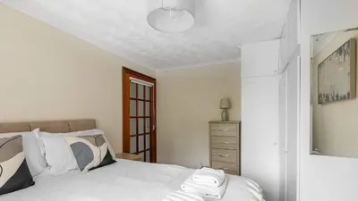 a bedroom with a bed and a dresser in it at Craigend Cottage in Rothesay