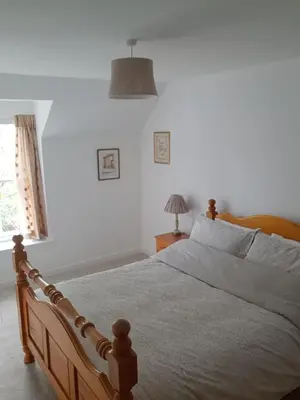 a bedroom with a bed and a window at Cosy Cottage in Moffat, South Scotland in Moffat