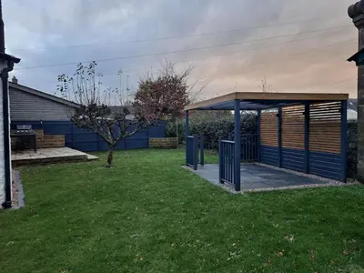 a bus stop in a yard next to a building at Cosy Cottage in Moffat, South Scotland in Moffat