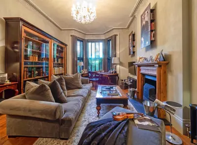 a living room with a couch and a fireplace at West London Boutique Apartment in Moffat