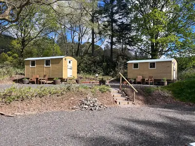 two mobile homes on the side of a road at Melfort House in Kilmelford