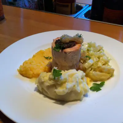 a white plate of food with meat and mashed potatoes at Melfort House in Kilmelford