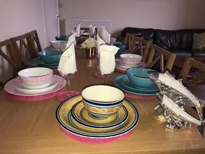 a table with plates and bowls on top of it at Edinburgh Central Morrison Roomz in Edinburgh