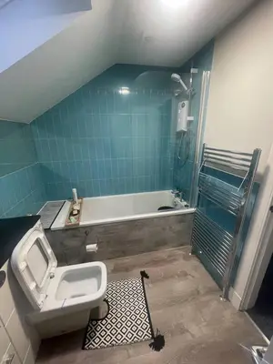a bathroom with a toilet and a bath tub at ShekNup Home in Edinburgh