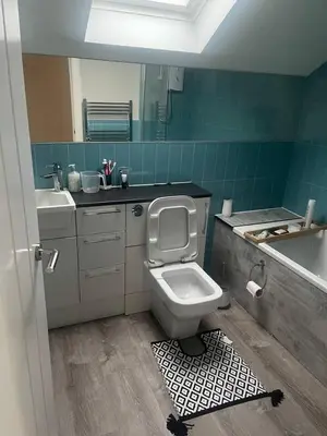 a bathroom with a toilet and a sink and a mirror at ShekNup Home in Edinburgh