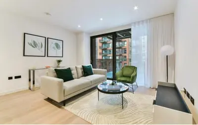 a living room with a couch and a table at 2 bed Luxury apartment with balcony in Moffat