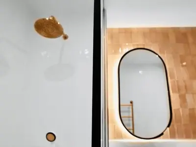a mirror on the door of a bathroom at 2 bed Luxury apartment with balcony in Moffat