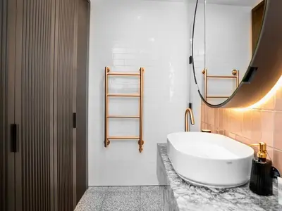 a bathroom with a large white tub and a mirror at 2 bed Luxury apartment with balcony in Moffat