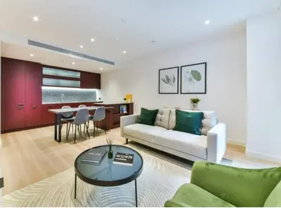 a living room with a couch and a table at 2 bed Luxury apartment with balcony in Moffat