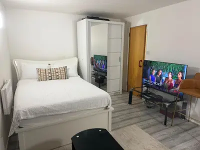a bedroom with a bed and a flat screen tv at House of Card in Moffat