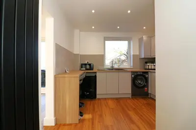 a kitchen with a counter and a dishwasher at Signature - Duncan House in Wishaw