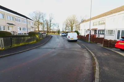 a small white van parked on the side of a street at Signature - Duncan House in Wishaw