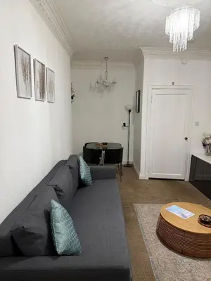 a living room with a couch and a table at Stylish Glasgow Apartment in Whiteinch